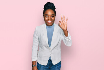 Sticker - Young african american woman wearing business clothes smiling positive doing ok sign with hand and fingers. successful expression.