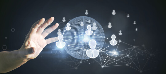 Poster - Hand using glowing globe interface with people icons on dark background. Social networking and recruiting concept.