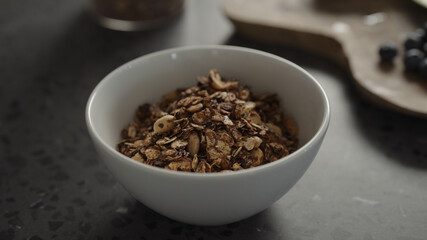 Wall Mural - pour granola over yogurt in white bowl