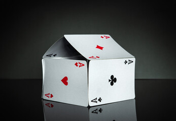 House of cards with aces on a dark background. The idea of winning a cottage or a mansion