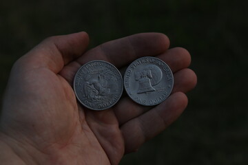 Two vintage American coins in hand