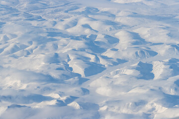 Sticker - Aerial view of snow-capped mountains and clouds. Winter snowy mountain landscape. Great background.