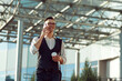 © yurolaitsalbert - young man with a takeaway coffee and a smartphone walking along