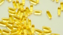 Fish Oil On A Light Background.Falling Fish Oil Capsules.omega Fatty Acids.Natural Supplements And Vitamins.Healthy Eating And Food Supplements. High Quality 4k Footage