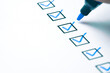 Blue marking on checklist box with pen, Checklist concept