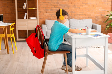 Poster - Little boy in headphones painting at home