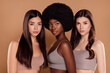 © Beauty Hero - Photo of adorable serious three best friends wear cropped tops embracing isolated beige color background