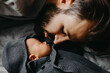 © Ananass - Silhouette of a stylish bearded father kisses a sleeping newborn girl. Parent holding rocking child daughter son in hands. Authentic lifestyle parenting fatherhood moment. Single dad family home life.