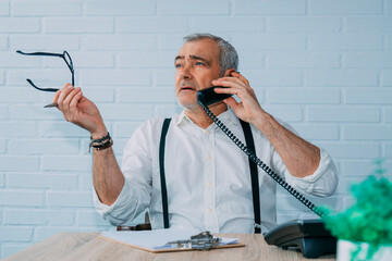 Wall Mural - hipster man with landline phone working at home or office