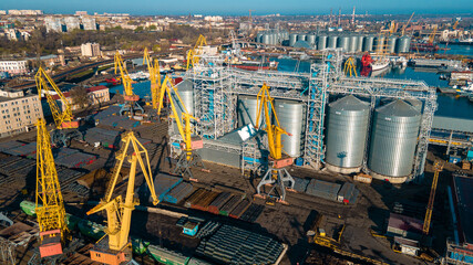 Wall Mural - Industrial port in the field of import-export global business logistics and transportation, Loading and unloading container ships, cargo transportation from a bird's eye view.