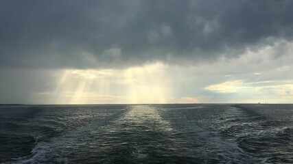 open north sea with dramatic sky after a rain storm. dark clouds and rays of sunshine. filmed from t