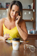 © ksenija1803z - portrait of smiling woman eats dessert and talking o smartphone