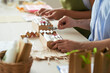 © DragonImages - Hands of people putting handmade soap in boxes and decorating with lavender branches