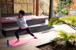 © Wavebreak Media - Mixed race woman practicing yoga on yoga mat with bottle of water