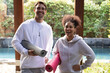 © Wavebreak Media - Portrait of happy diverse couple holding yoga mats before practicing yoga