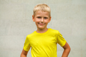 Blonde little boy in a summer park