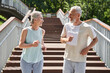 Happy senior couple running with delight at the summer park and trying to keep body fit