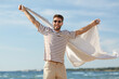 © Syda Productions - summer holidays and people concept - portrait of happy smiling young man in sunglasses with blanket having fun on beach