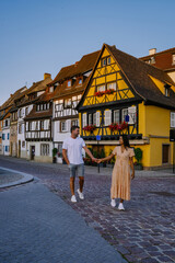 Wall Mural - Colmar, Alsace, France. Petite Venice, water canal, and traditional half timbered houses. Colmar is a charming town in Alsace, France. couple man and women walking at the street during vacation