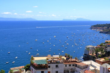 Wall Mural - Mediterranean landscape. Sea view of the Gulf of Naples and the silhouette of the island of Capri in the distance. The province of Campania. Italy.