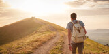 Fototapeta  - Young man travels alone walking on trail and enjoying on view of mountains and sea landscape at sunset , the lifestyle concept of traveling outdoors.
