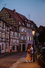 Wall Mural - Colmar, Alsace, France. Petite Venice, water canal, and traditional half timbered houses. Colmar is a charming town in Alsace, France. couple man and women walking at the street during vacation