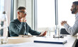 © insta_photos - Serious focused mature businessman employer hr or client holding cv or contract listening manager, applicant during job interview, two diverse ethnic partners having negotiations at office meeting.