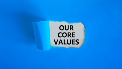 Our core values symbol. Words 'Our core values' appearing behind torn blue paper. Beautiful blue background. Business, our core values concept, copy space.