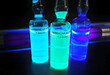 Harmala alkaloid fluorescent solutions ampoules stock images. Laboratory accessories. Chemical reaction images. Chemical container with purple liquid. Laboratory analysis samples in glass containers