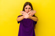 © Asier - Young caucasian woman isolated on yellow background doing a denial gesture