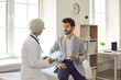 © Studio Romantic - Young man discussing health issues and problems with doctor. General practitioner and male patient talking about course of treatment in medical office or exam room of modern clinic or hospital