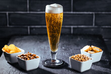 Glass Of Beer On A Dark Background With Different Snacks