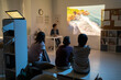 © pressmaster - Schoolkids watching movie about natural environment at lesson of biology