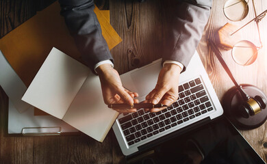 Business and lawyers discussing contract papers with brass scale on desk in office. Law, legal services, advice, justice and law concept picture with film grain effect