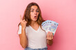 © Asier - Young caucasian woman holding bills isolated on pink background  having some great idea, concept of creativity.