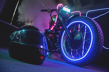 Black Motorcycle Helmet In The Neon Lights. Motorbike Store Showroom Concept.