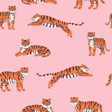 Fototapeta Dinusie - Vector seamless pattern with cute tigers on the pink background. Circus animal show. Tiger year. Fashionable fabric design.