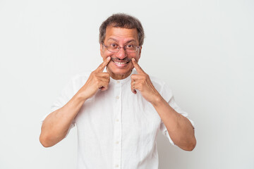 Middle aged indian man isolated on white background doubting between two options.