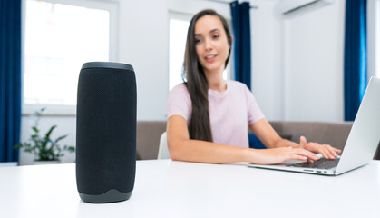 Woman using smart speaker, home assistant