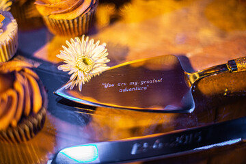 silver cake serving utensils engraved with the phrase 