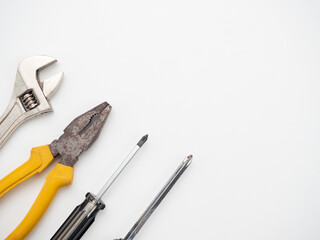 Adjustable wrench screwdriver pliers on white background top view,Technician tools on white background copy space