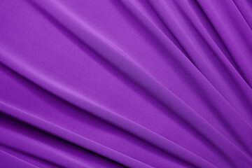 Smooth elegant violet satin texture can use as abstract background. Luxurious background design. Closeup purple texture