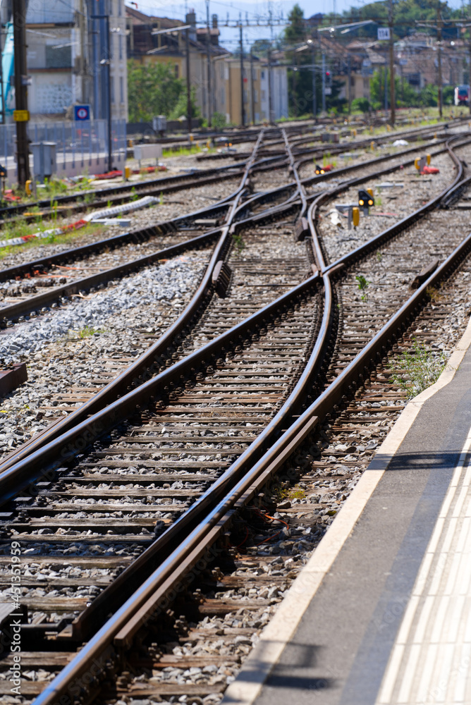 Railway tracks with switches at railway station Lausanne on a sunny summer day. Photo taken July 29th, 2021, Lausanne, Switzerland.