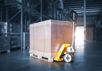 Package Box with Hand pallet Truck Load in Storage Warehouse. Storehouse, Shipping Warehouse Logistics.	