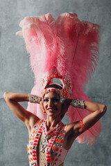 Wall Mural - Woman in samba or lambada costume with pink feathers plumage.