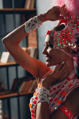 Wall Mural - Woman in samba or lambada costume with pink feathers plumage.