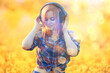 © kichigin19 - audio headphones summertime girl music in a field of flowers, young female spring