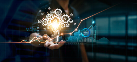 Leinwandbilder - Businessman holding light bulb and cog inside. Creative and inspiration. Media and new idea for business of finance and economic growth. Innovation and technology on network.