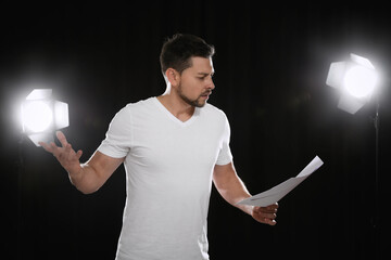 Professional actor reading his script during rehearsal in theatre