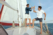 Young male friends resting on yacht in sea